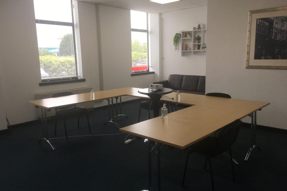 Professional meeting room setup with large windows, whiteboard, and modern furniture. meeting room hire offers cost savings, flexible scheduling, and a professional environment for small businesses and startups