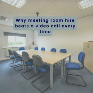 a meeting room set up with a large central time and blue chairs around in a light room at obsifian offices showing meeting rooms for hire