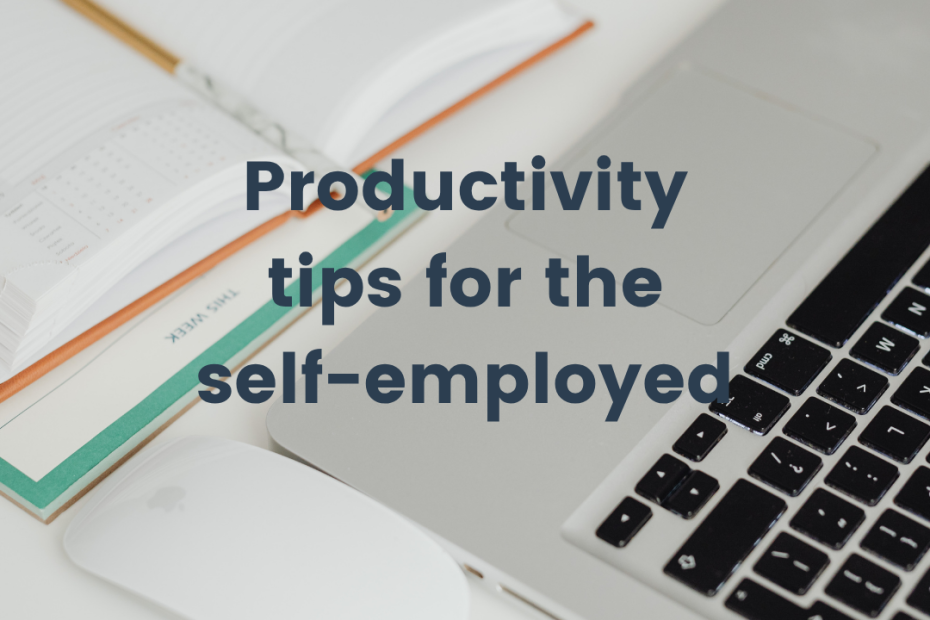 a white desk with a keyboard and a planner opened out showing productivity tips ofr the self-employed